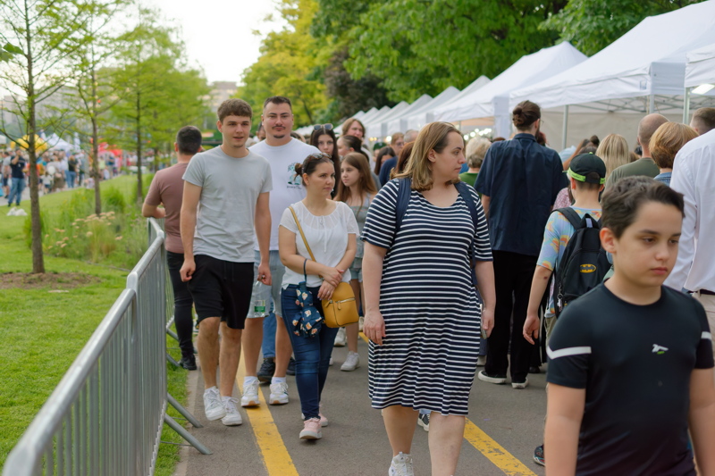 People on a lively outdoor market festival, the West Side Flower Fest in Bucharest